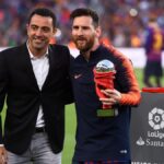 Xavi with Messi holding the trophy